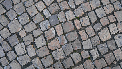Obraz premium Stone Paving, Texture. Gray square cobblestone sidewalk. Road paved with granite. Top view on european stone road, closeup. Mock up or vintage grunge texture. For design.