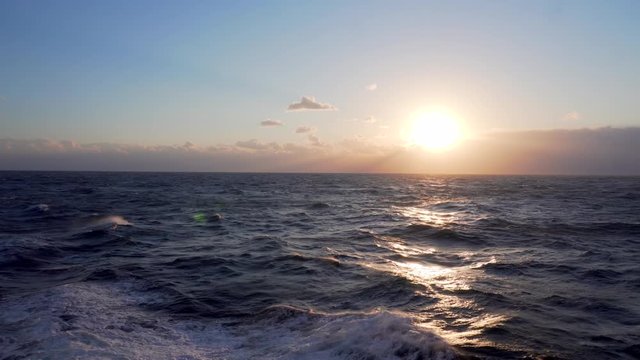Beautiful sea sunset. Small waves on the high seas during a beautiful sunset. Rema for relaxation.