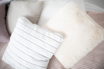Small square pillows on the sofa are light.