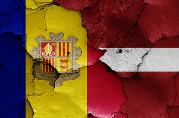 flags of Andorra and Latvia painted on cracked wall