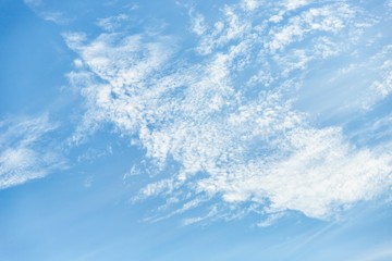 Naklejka na ściany i meble White cirrocumulus clouds in the blue sky. Beautiful sky background