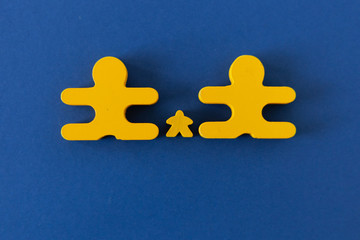 figures of little men mom dad children yellow on a blue background, concept family