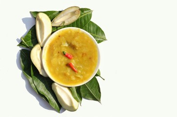Mango Chutney or Cuisine in a Plate with Raw Mango and Leaves Isolated on White Background with Copy Space
