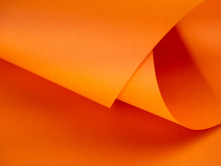 Abstract bright orange paper background for your design. Three-dimensional geometric image. Selected sharpness.