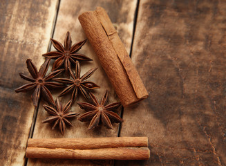 Star anise and cinnamon sticks on a wooden background