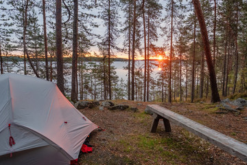 Tourist camping at sunrise in the finnish national park in Karelia, Finland.