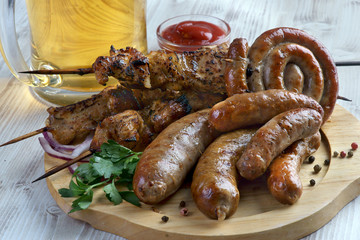grilled sausages and shish kebabs with a glass of light beer