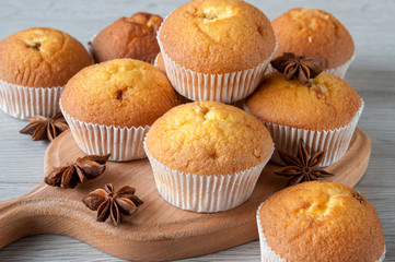 Delicious fresh muffins with star anise on a wooden stand, cool after baking. Sweet dessert.