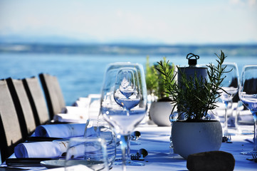 A full prepared table beside the lake close-up
