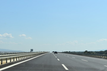 Driving on the fast lane on a long and endless straight road 