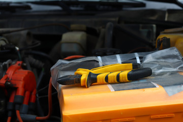 Fototapeta premium tool nippers are on the car, repair under the hood of the car, motor inspection