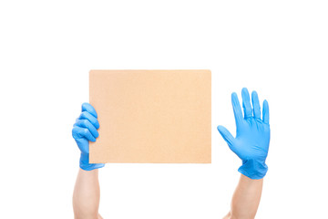 don`t harm to the life saver and stay at home, a cardboard paper in hand in medical gloves and a...