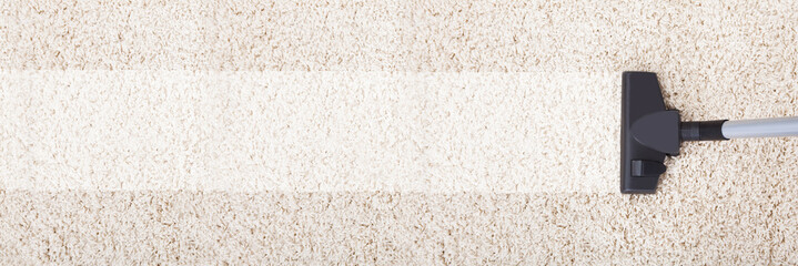 Vacuum Cleaner On Rug At Home