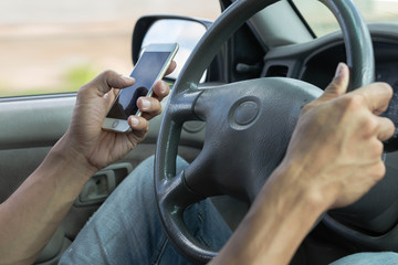Distracted dangerous driver using a phone in the car.  Careless driving.