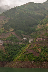 Shengli Street, China - May 6, 2010: Xiling gorge on Yangtze River. White and gray Farm houses on...