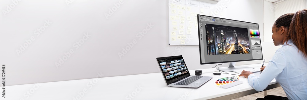 Poster Designer Editing Photos On Computer