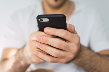 young man texting on his cellphone