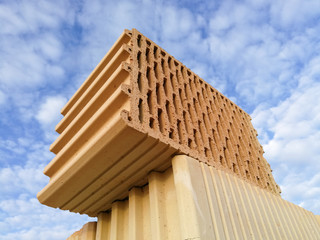 Ceramic building block close up in front of blue sky