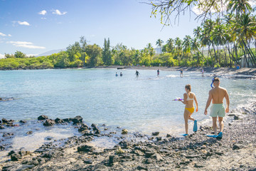 Tourists enjoying Kiholo Bay on the Big Island of Hawaii. 
