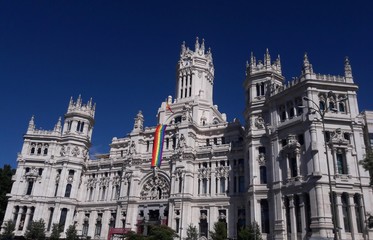 Fototapeta na wymiar Cybele Palace Madrid Spain city hall with rainbow flag for gay pride parade 2017