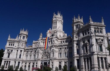 Fototapeta premium Cybele Palace Madrid Spain city hall with rainbow flag for gay pride parade 2017