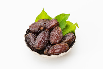 Palm dates on the silver plate, white background.