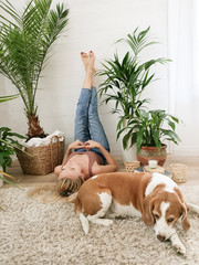 Girl with her dog relaxing at home.