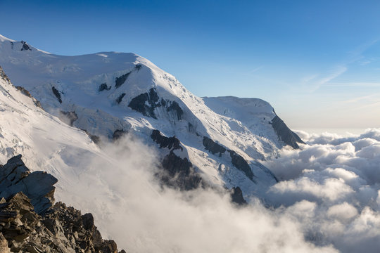 Clouds and fog near Dome du Gouter and Bosson glacier Mont Blanc massif in the French Alps. View from the Cosmique refuge, Chamonix, France. Perfect moment in alpine highlands.