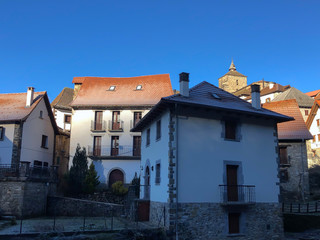 Fototapeta na wymiar Uztarroz, a beautiful and tiny village of Valle de Roncal, the Navarrese Pyrenees, Foral Community of Navarre (Spain). The traditional architecture of the Pyrenees.