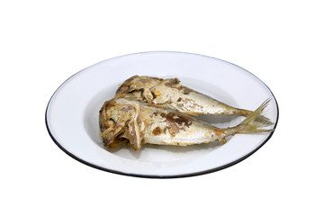 Two fried mackerel on a separate plate from a white background