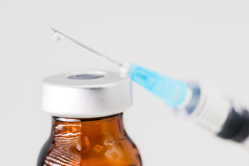 Medicine bottle for injection, medical glass vials and syringe for vaccination on white background .