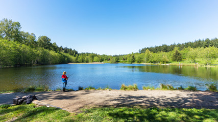 Fototapeta na wymiar fishing for rainbow trout at lake in park - spring, BC 