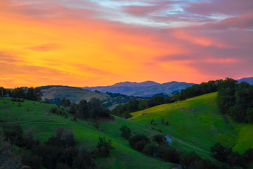 Landscape of beautiful California green hills at sunset