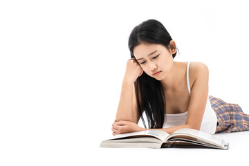 Girl lying on the floor and reading a book at home.