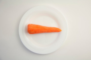fresh peeled carrots on a white plate and white isolated background