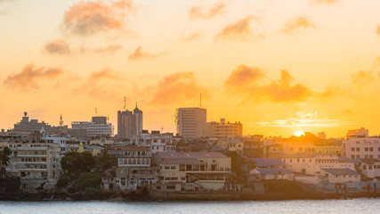 Sun set of Mombasa Island as seen from the main land, The sun rays from the sky lite up the buildings