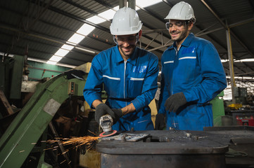 Industrial worker cutting metal and steel with many sparks