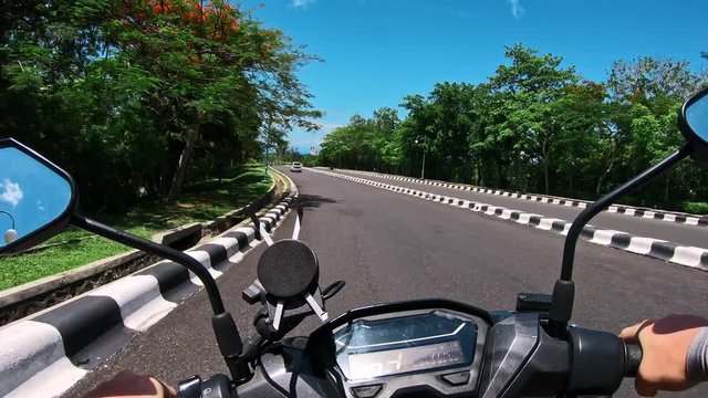 Riding a motorcycle on a paved road in the first person