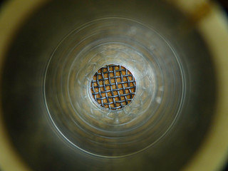 abstract circle made by photographing a microphone mesh through a glass guitar slide