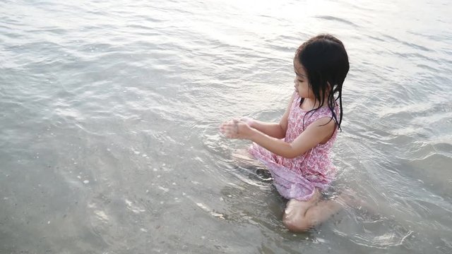 Asian children have fun to play on the beach in the summer holiday
