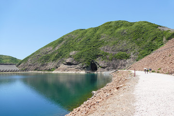Huge hexagonal columnar joints of volcanic rock at Hong Kong Global Geopark, China, with cave made...