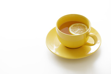 cup of tea with fresh yellow lemons on white background