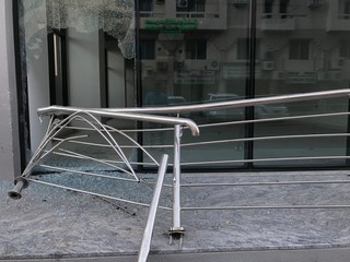 Somebody broke toughened glass partition for stealing the things from an commercial shopping center