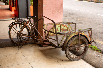 Fototapeta na wymiar Three wheeled bike with cargo platfrom on front