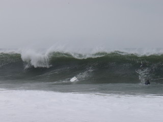 bodyboarders bail their boards to duck dive a huge wave