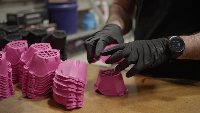 Employee QC's face masks after they come out of Injection molding machine