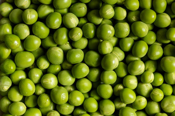 Fresh green peas background. Macro, close-up & top view. Concept of healthy food. Texture.