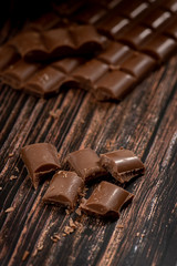Delicious and tasty milk chocolate bar on a wooden background