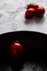 Red fresh healthy tomatoes isolated on a black pan