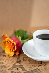 Orange yellow rose with a cup coffee
